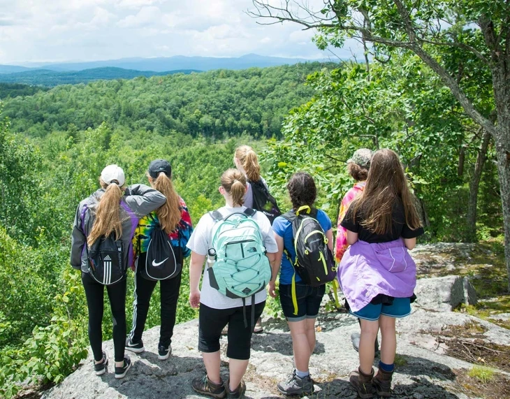 Campers take in the view of Bullhead Pond during a hike at GMCC Kehoe.